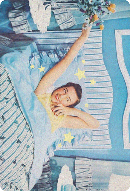 Retro-style illustration of a smiling woman stretching in bed, holding flowers, surrounded by soft blue tones and star accents.