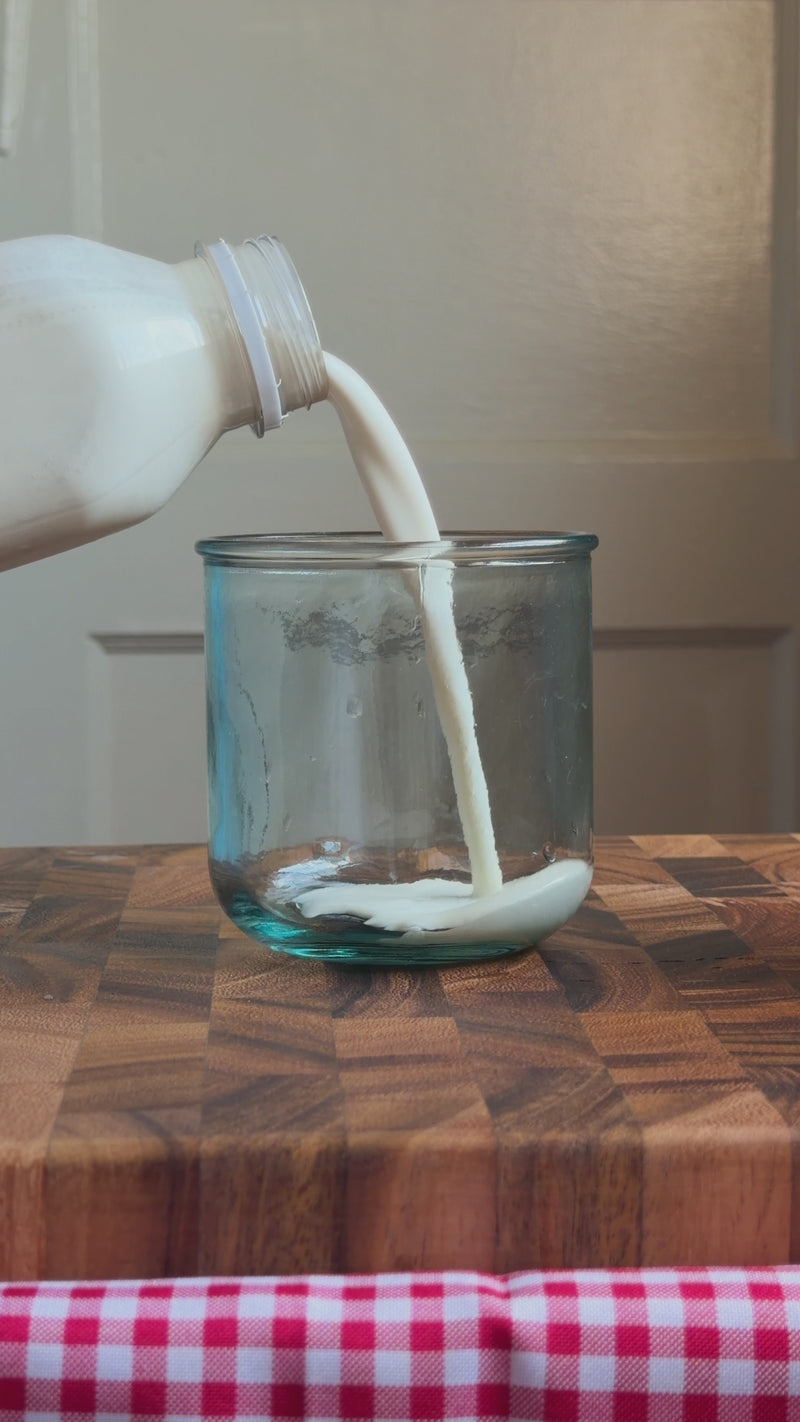 Heavy whipping cream, whole milk, simple syrup, and vanilla syrup being frothed into a creamy foam topping.