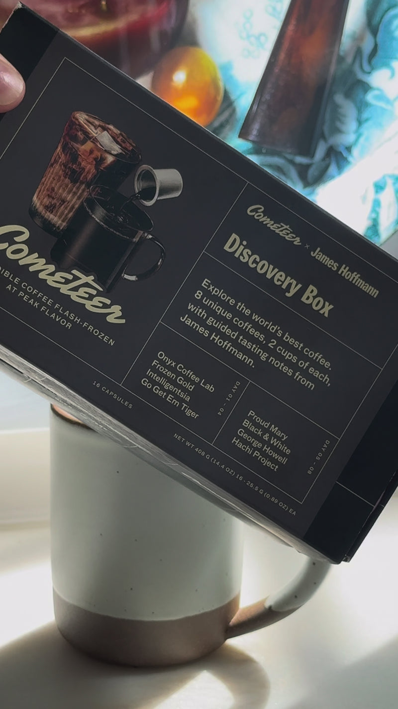 A hand prepares a hot latte by pouring a Cometeer coffee capsule into a mug, followed by hot water and steamed milk. The video begins with a close-up of the Cometeer coffee box, then shows each ingredient being added step-by-step, blending into a smooth, creamy base for a cozy THC/CBD coffee drink.