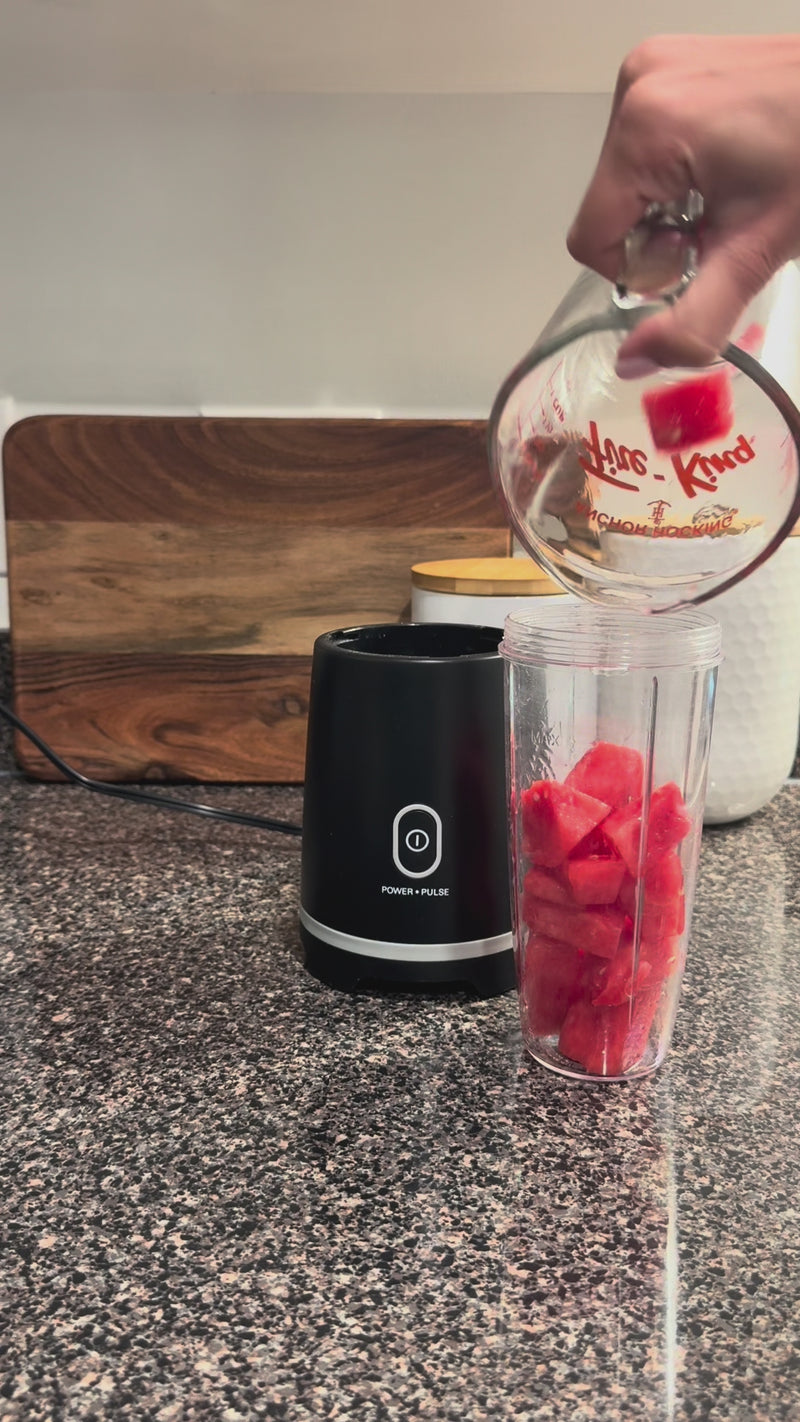 Fresh watermelon, lime juice, and simple syrup being added to a blender and blended into a smooth watermelon mixture.