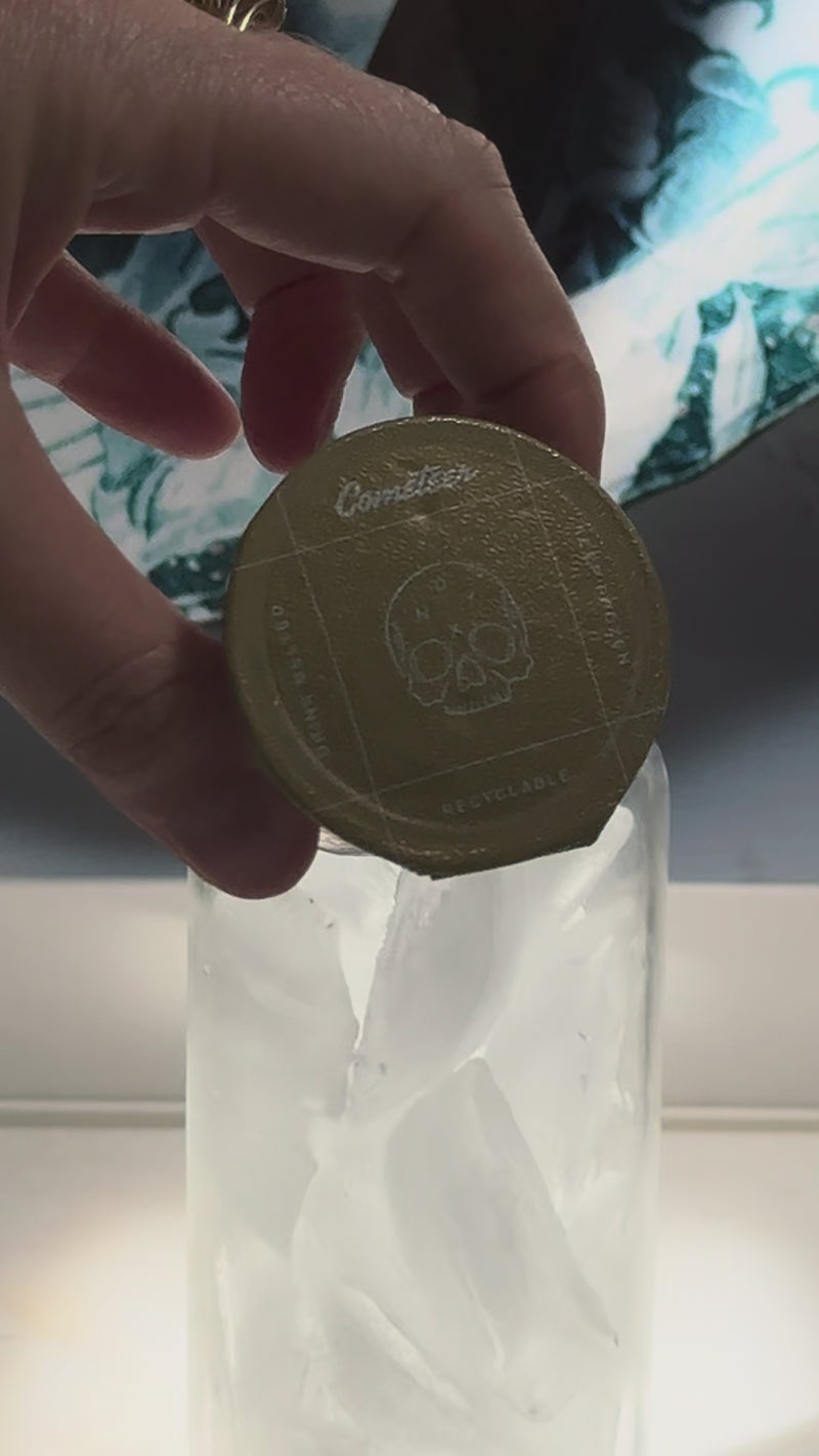 A tall glass filled with ice as melted Cometeer coffee, water, and milk are poured together, creating the smooth base for a THC/CBD iced latte.