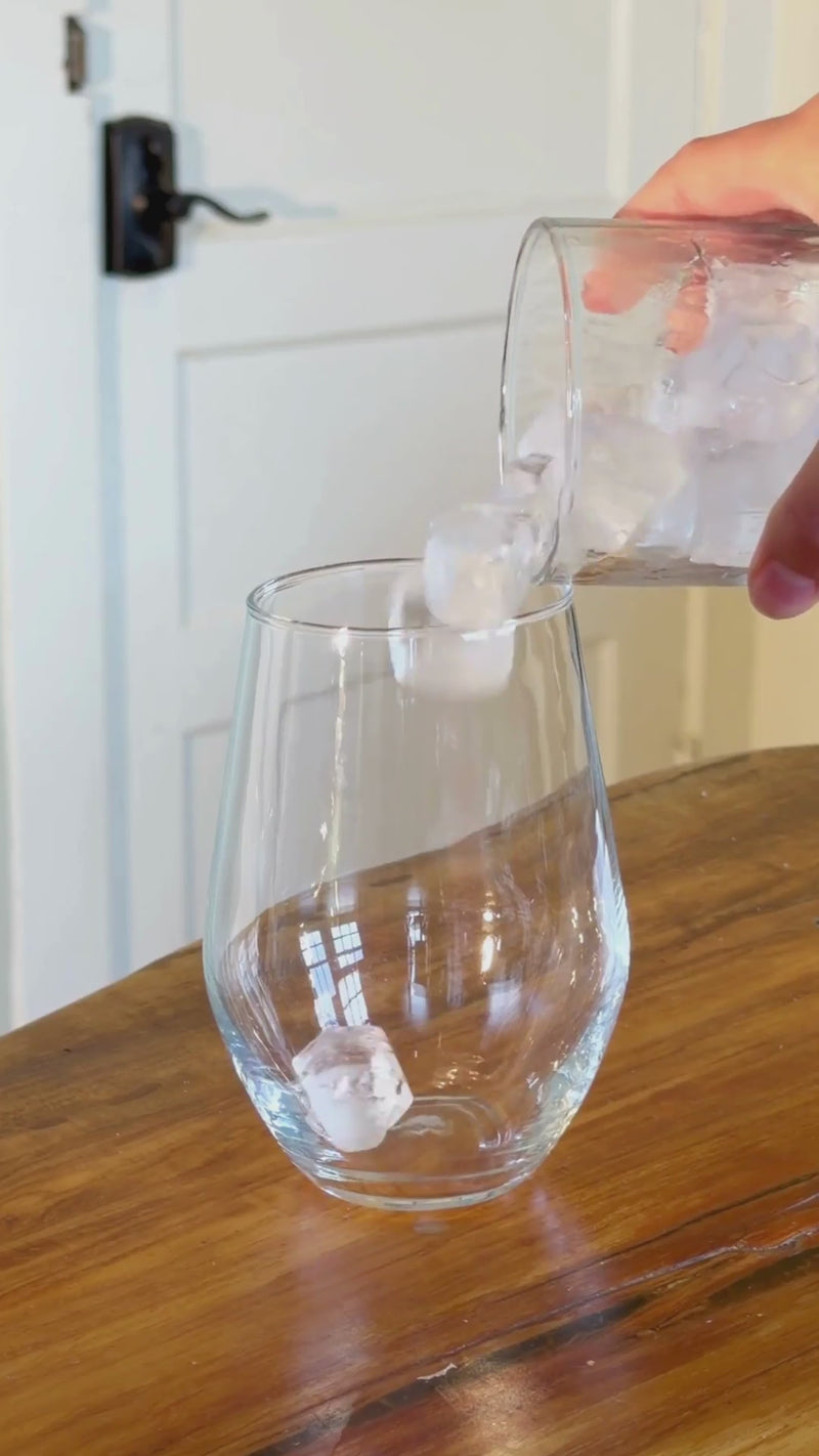 Ice and your favorite soda being poured into a tall glass to build the base of a creamy Dirty Soda.