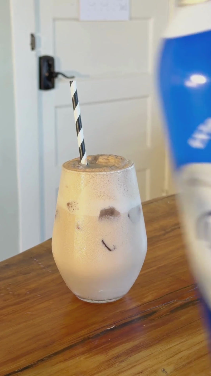 Whipped cream being added to the finished Dirty Soda for a rich, creamy topping before serving.
