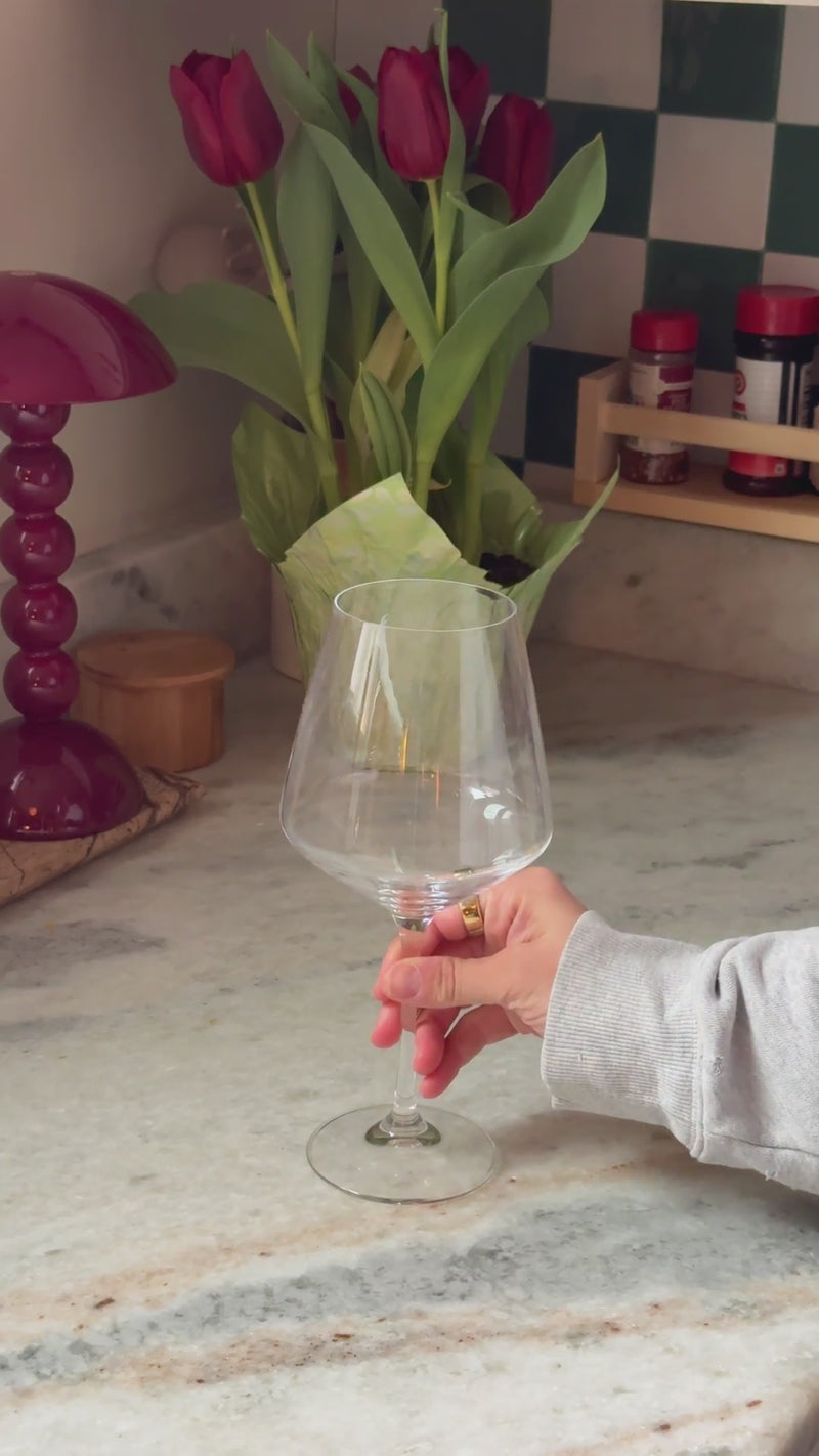 Tart cherry mixture strained into a stemmed wine glass filled with fresh ice and topped with sparkling water.