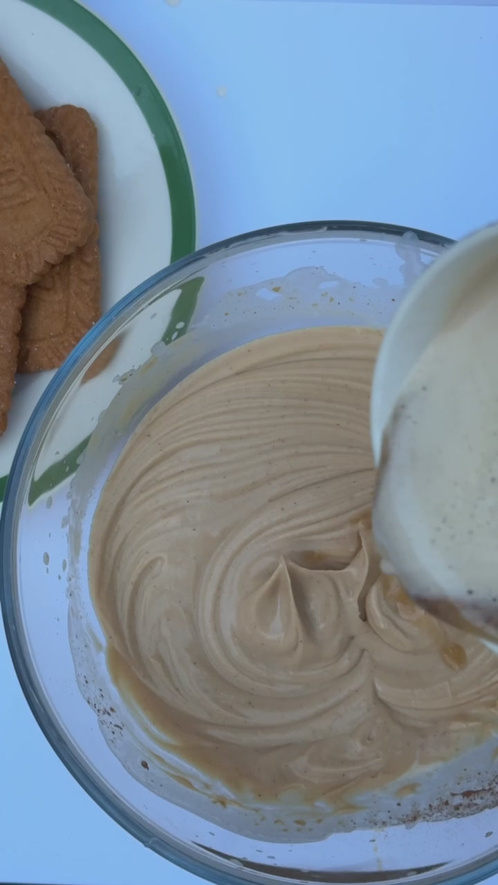 Coffee is poured into the glass mixing bowl with the cookie butter mixture, then mixed again until smooth.