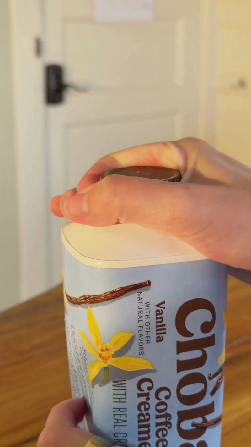 Half-and-half or heavy cream being poured into an ice-filled Dirty Soda, creating a rich, creamy swirl through the soda before stirring.