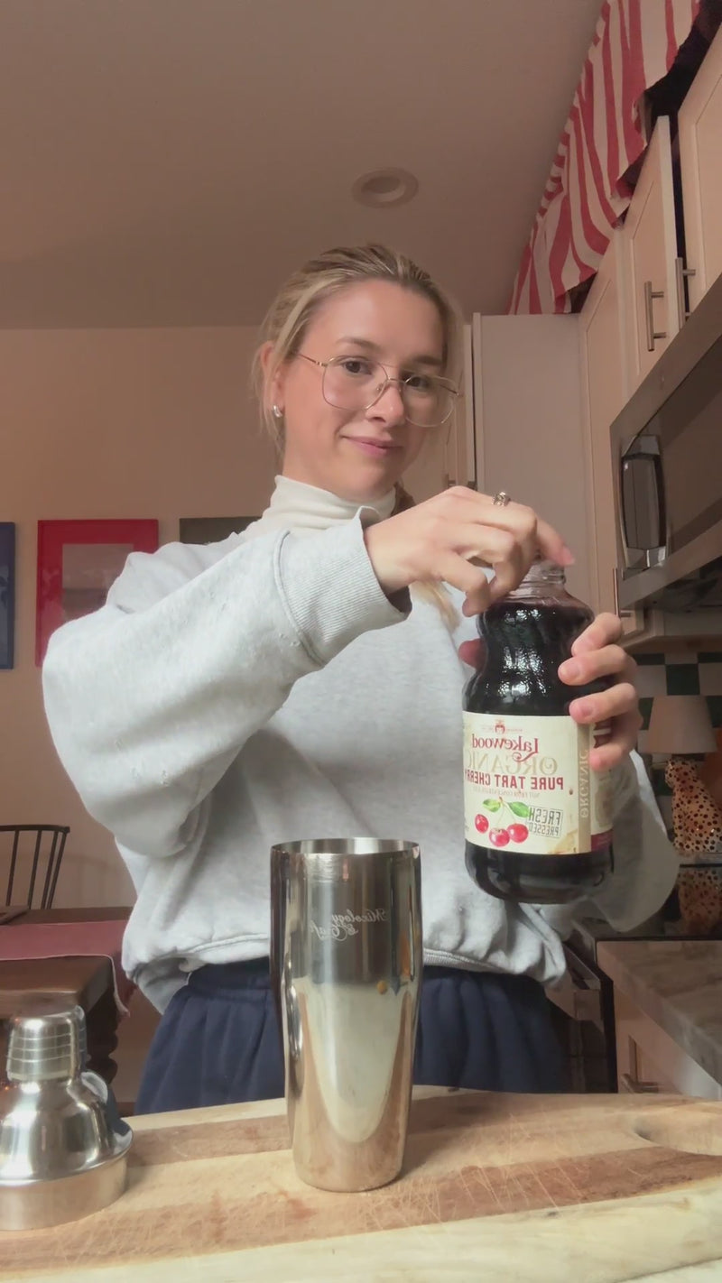 Tart cherry juice, fresh lemon juice, agave, and rosemary added to a cocktail shaker.