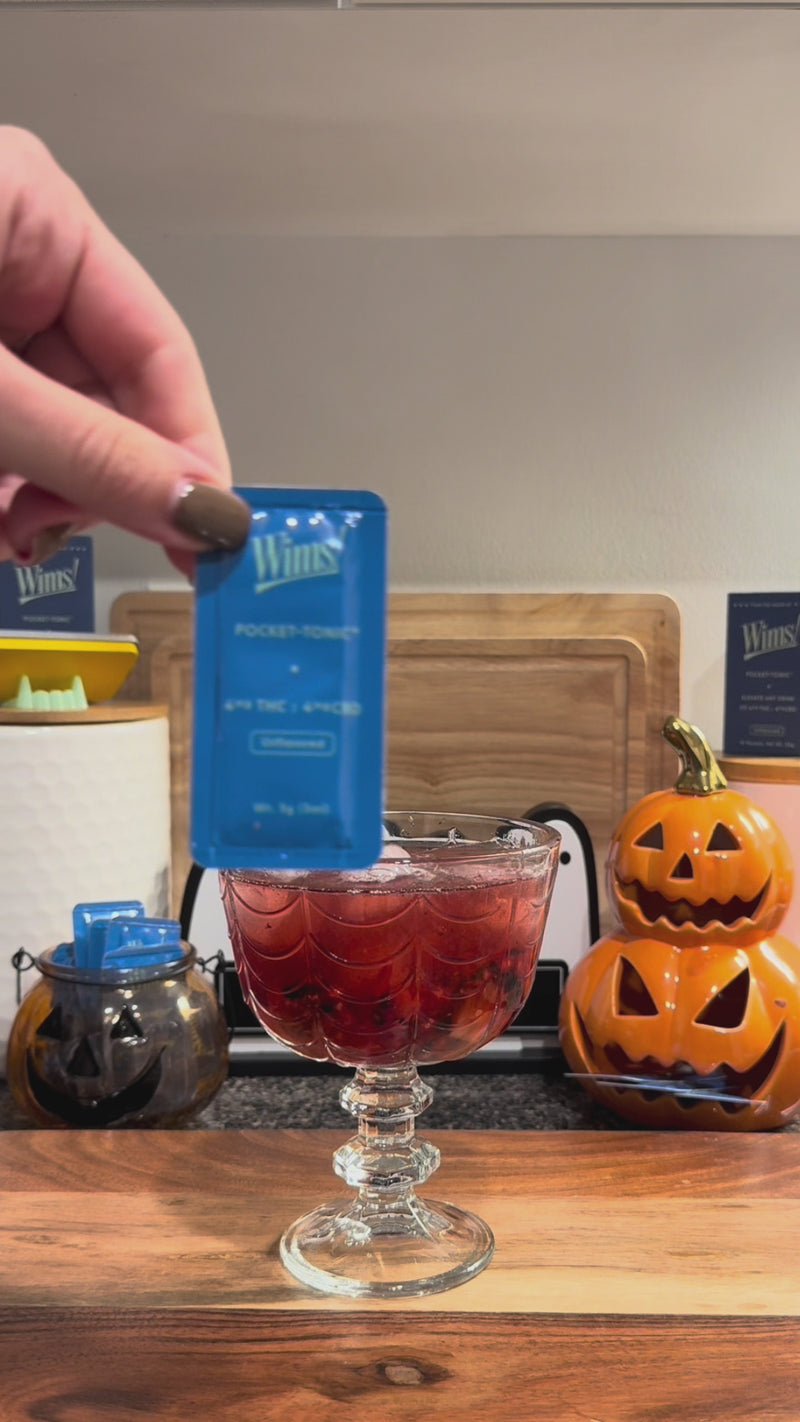Unflavored Wims Pocket-Tonic™ being snapped into the Triple Berry Spritz and stirred until combined.