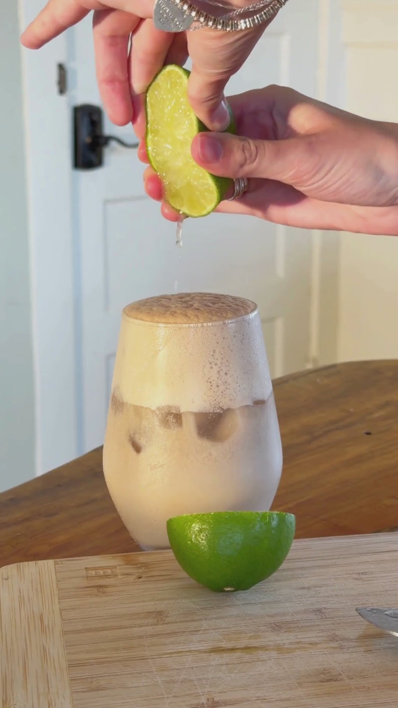 Unflavored Wims Pocket-Tonic™ being snapped, squeezed, and stirred into the Dirty Soda with fresh lime juice until fully incorporated.
