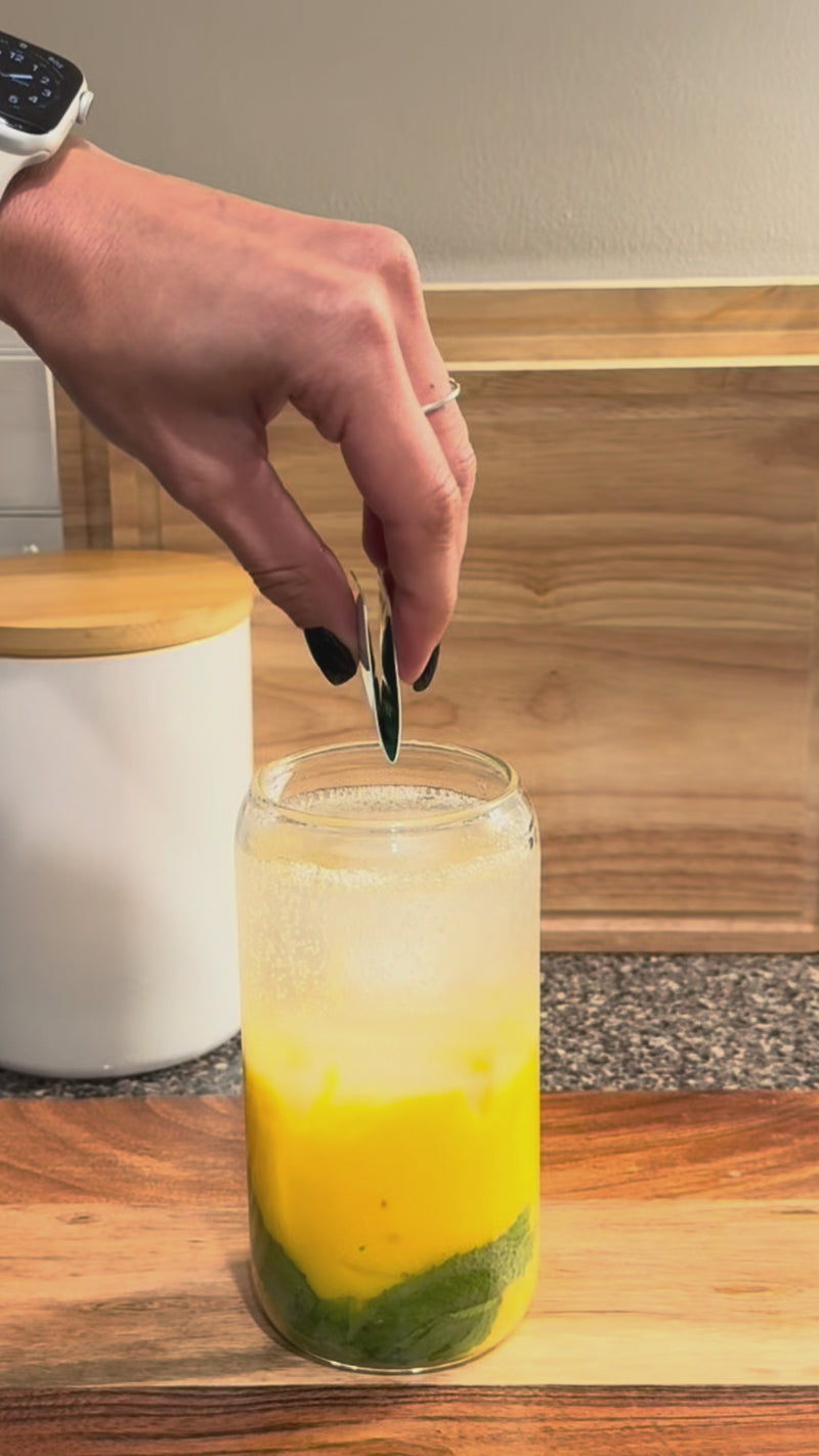 Lemon Basil Wims Pocket-Tonic™ being added to the Mango Mojito and stirred before garnishing with fresh lime and mint.