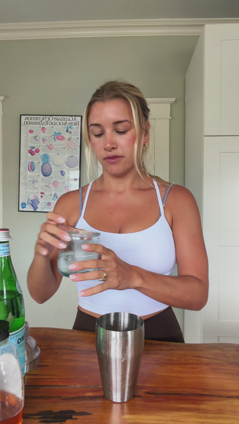 Ice being added to a cocktail shaker to start the Wims Pickletini.