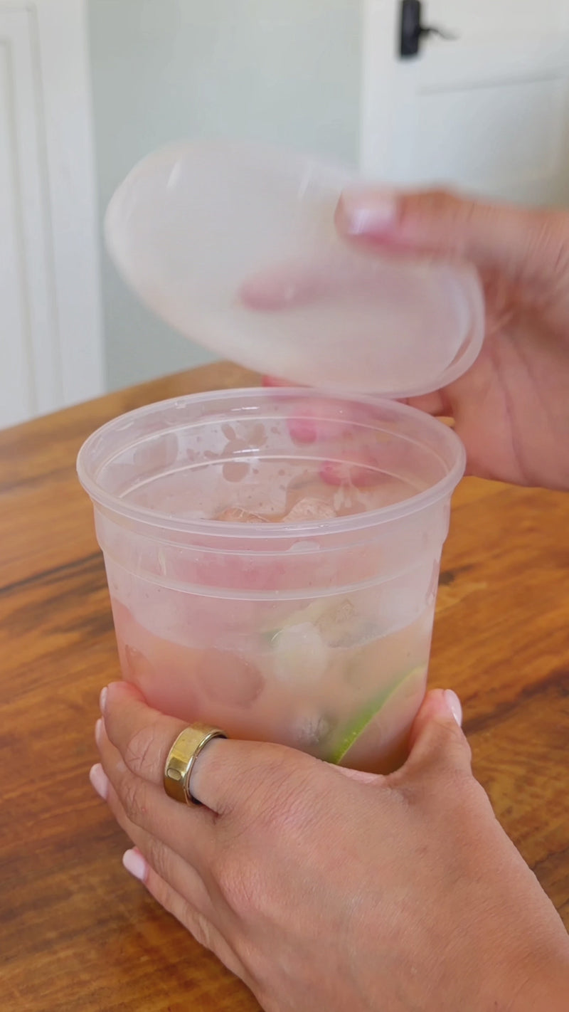 Sparkling water poured into a grapefruit lime spritz, finished with a straw and ready to sip.