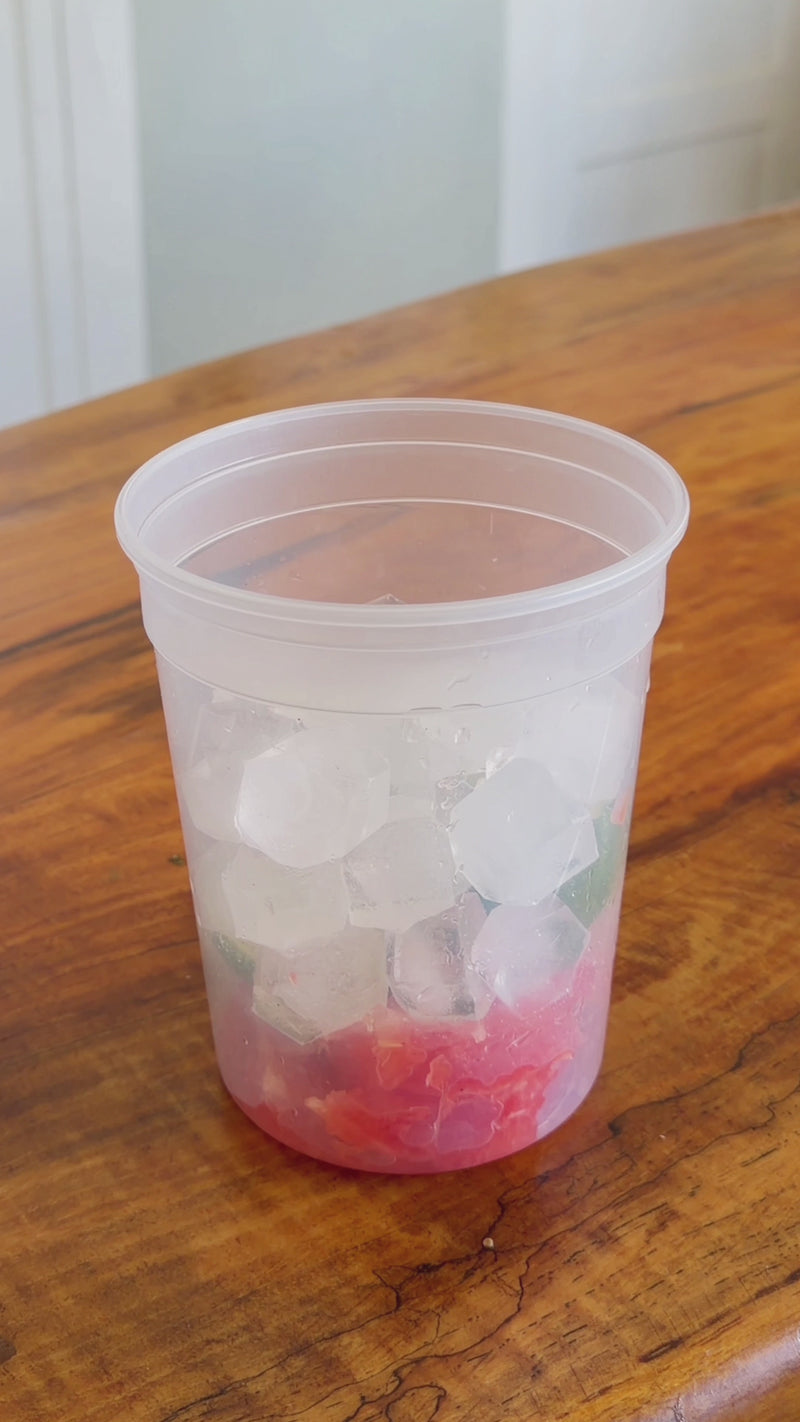 Fresh grapefruit juice being poured into a deli container, then 2 Wims Pocket-Tonic™ sachets being added.