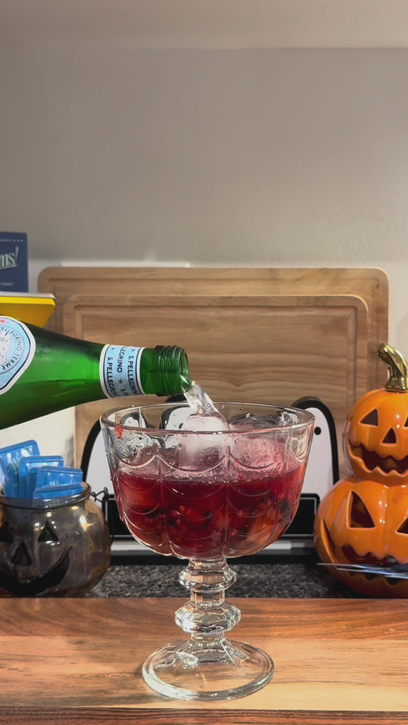 Sparkling water being poured into the Triple Berry Spritz for a bubbly finish.