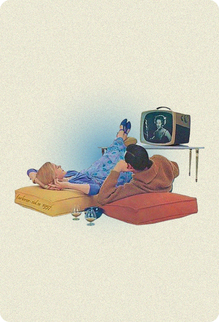 Couple lounging on floor cushions watching television together, representing relaxed evenings and mindful unwinding with Wims.
